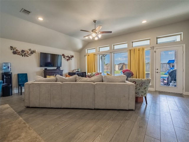 living room with light hardwood / wood-style flooring, ceiling fan, and lofted ceiling