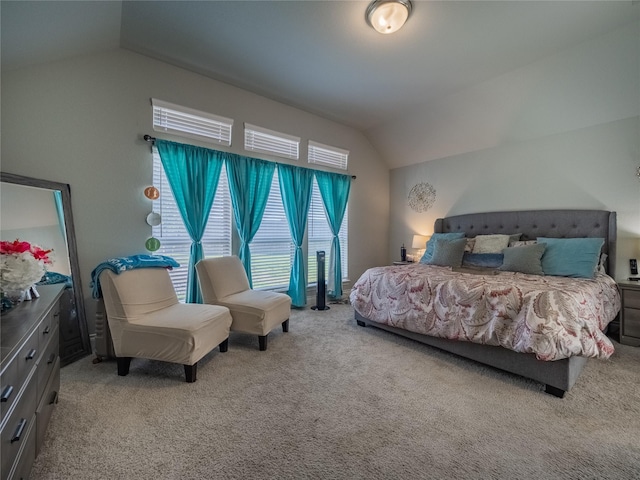 bedroom featuring light carpet and vaulted ceiling