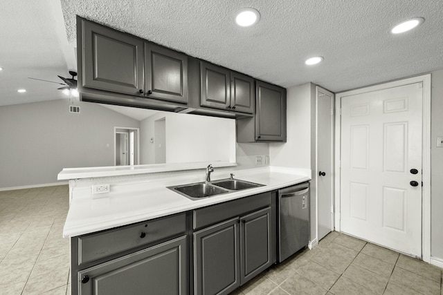 kitchen featuring kitchen peninsula, stainless steel dishwasher, a textured ceiling, ceiling fan, and sink