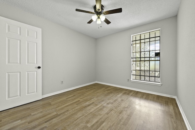 spare room featuring ceiling fan, a textured ceiling, and hardwood / wood-style flooring