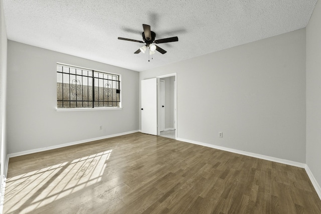 unfurnished room with hardwood / wood-style flooring, ceiling fan, and a textured ceiling