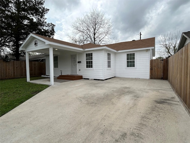 ranch-style house featuring a carport