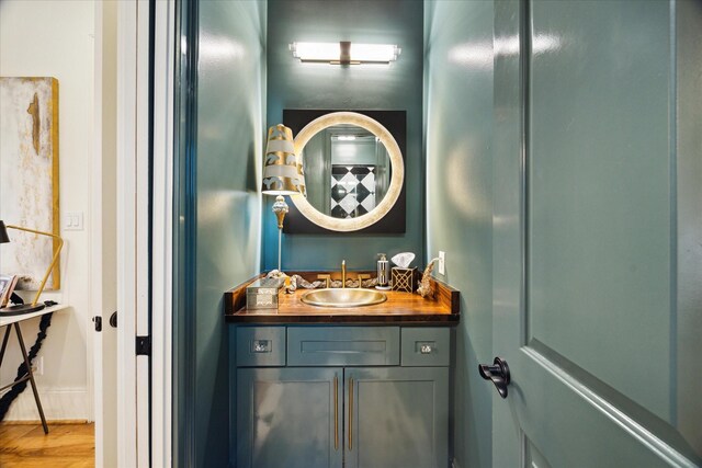 bathroom with hardwood / wood-style floors and vanity