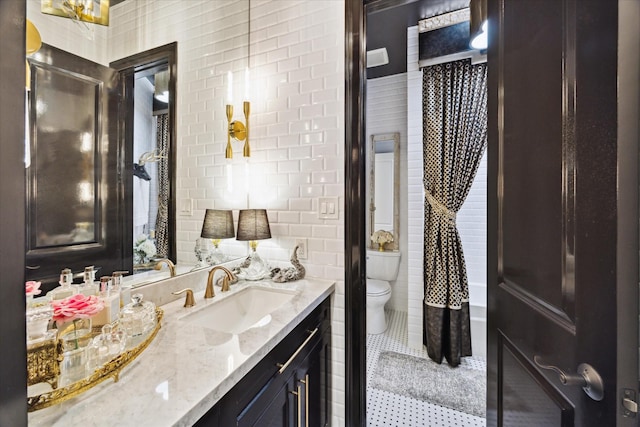 bathroom with tile patterned floors, vanity, and toilet