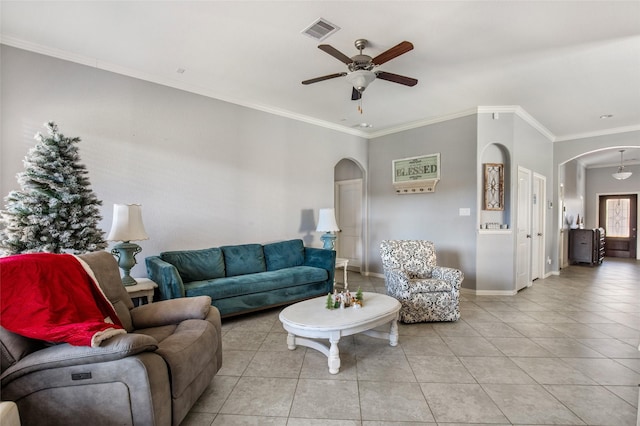 living room with ceiling fan, crown molding, and light tile patterned floors