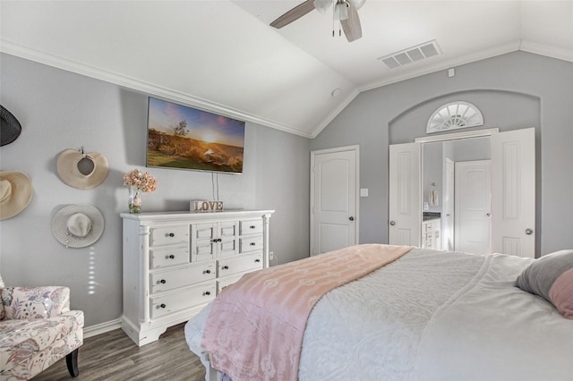 bedroom featuring ceiling fan, dark wood-type flooring, lofted ceiling, and ornamental molding