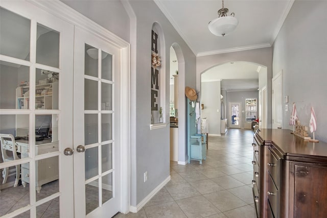 corridor featuring ornamental molding, light tile patterned floors, and french doors