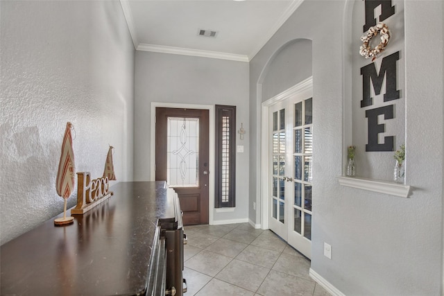 entrance foyer with crown molding and light tile patterned flooring