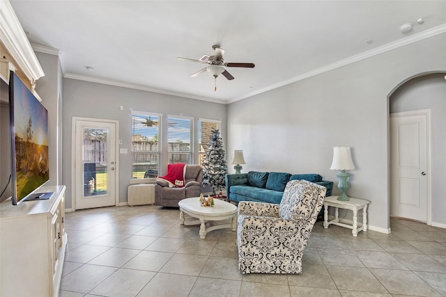 tiled living room featuring ceiling fan and crown molding