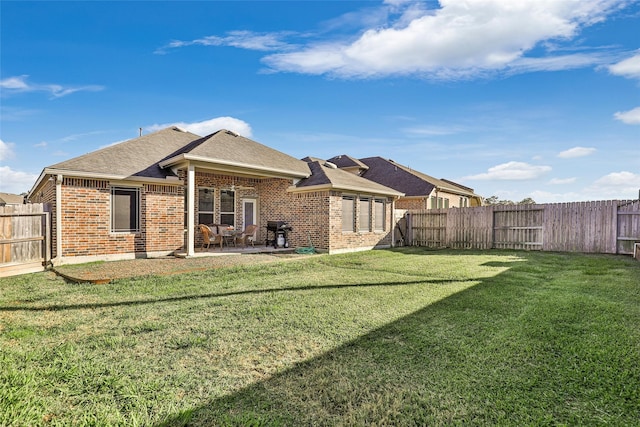 back of house featuring a patio and a lawn