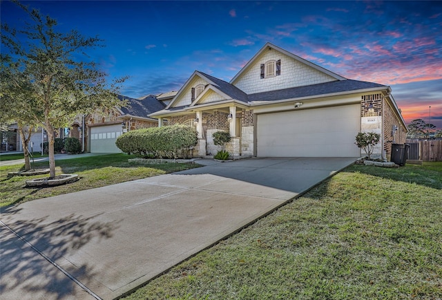 view of front of house featuring a yard and a garage