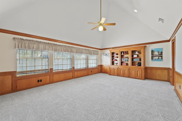 interior space featuring ceiling fan, light colored carpet, and lofted ceiling