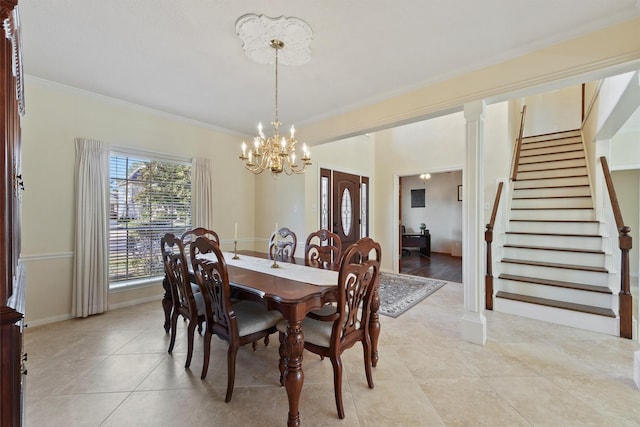 dining area with ornate columns, crown molding, light tile patterned floors, and a chandelier