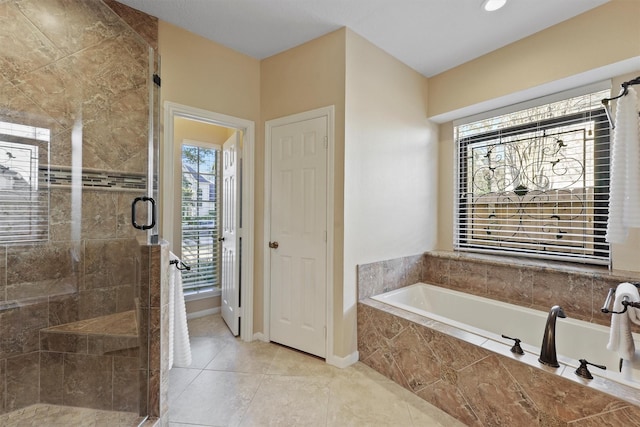 bathroom featuring tile patterned flooring and shower with separate bathtub