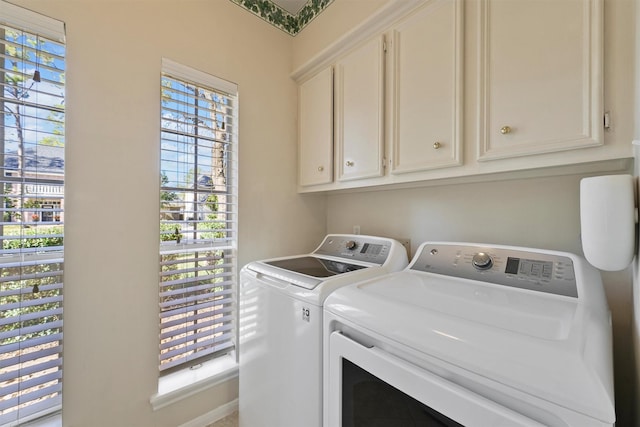 washroom with cabinets and separate washer and dryer