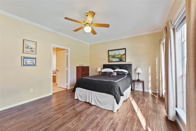 bedroom with hardwood / wood-style floors, connected bathroom, ceiling fan, and crown molding