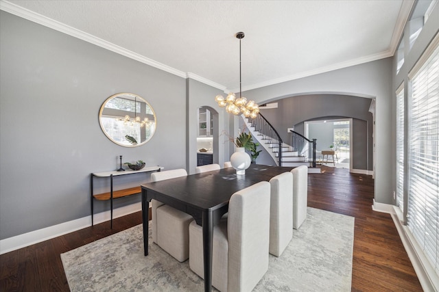 dining area featuring a notable chandelier, crown molding, and dark wood-type flooring