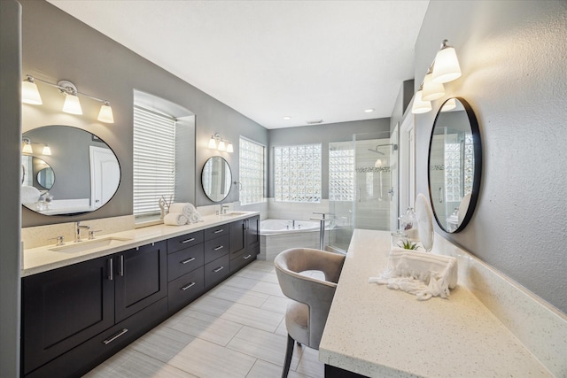 bathroom with vanity and separate shower and tub