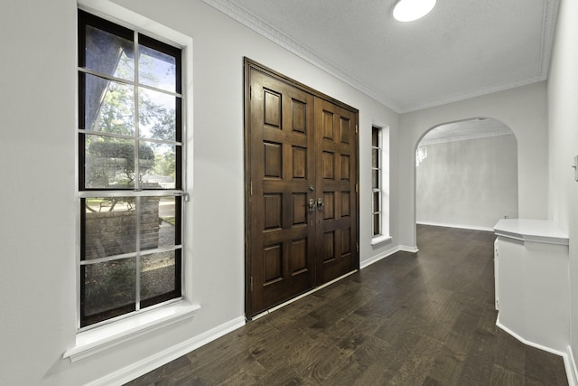 entrance foyer with crown molding and dark wood-type flooring