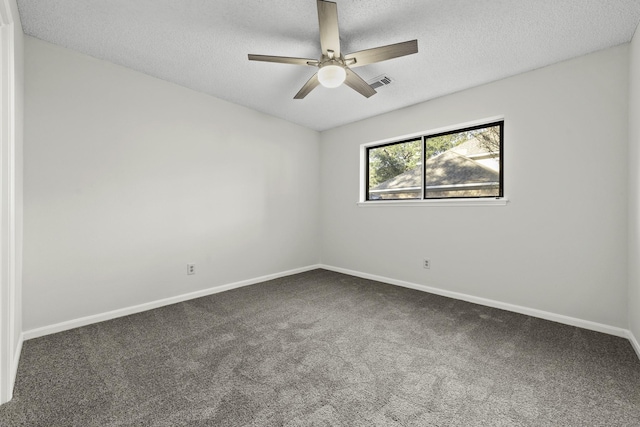 empty room with dark colored carpet, a textured ceiling, and ceiling fan