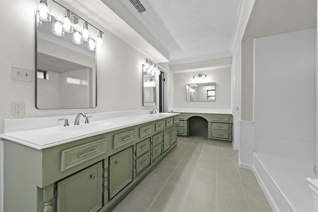 bathroom featuring crown molding, tile patterned flooring, vanity, and a textured ceiling