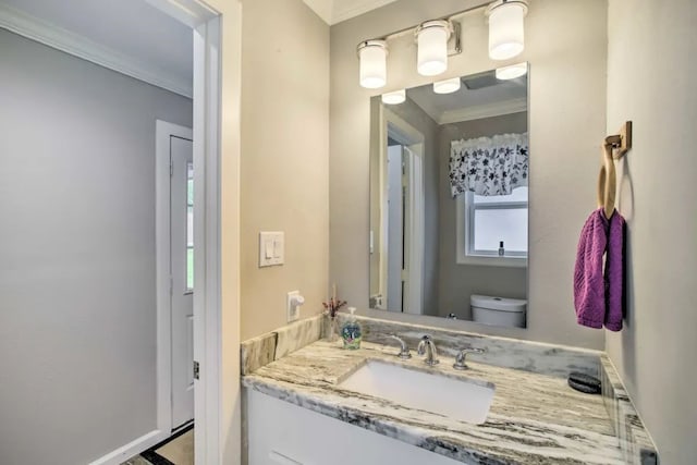 bathroom with vanity, toilet, and crown molding