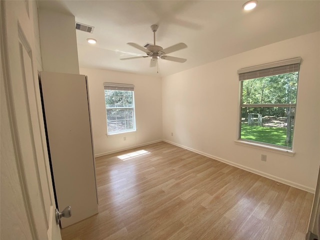 spare room with ceiling fan and light hardwood / wood-style floors