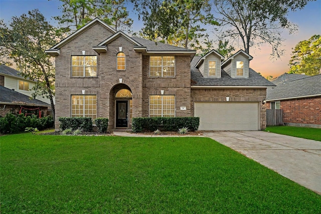 view of front of property featuring a yard and a garage