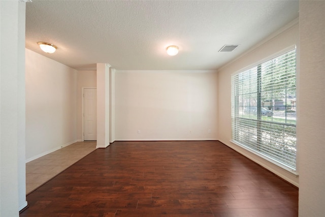 spare room with dark hardwood / wood-style floors and ornamental molding