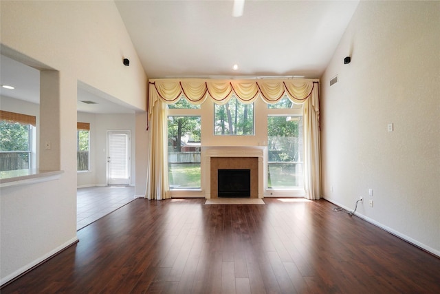 unfurnished living room with dark hardwood / wood-style flooring and vaulted ceiling