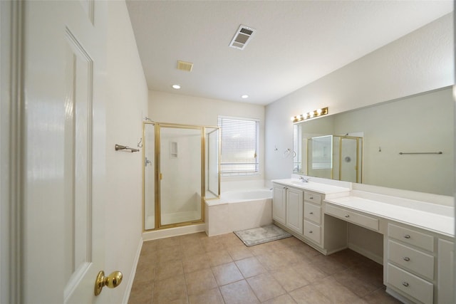 bathroom featuring tile patterned flooring, vanity, and shower with separate bathtub