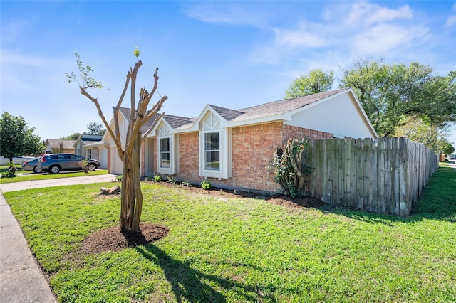 ranch-style home featuring a garage and a front lawn