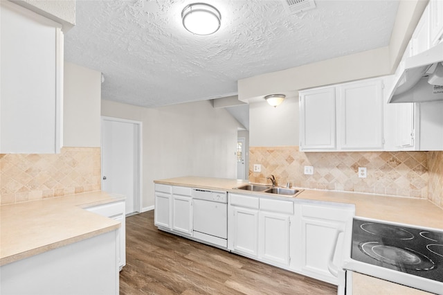 kitchen with white cabinets, stove, and sink