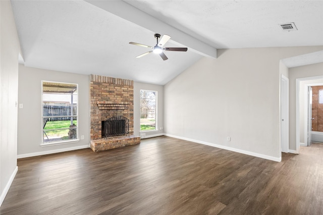 unfurnished living room featuring a fireplace, ceiling fan, dark hardwood / wood-style flooring, and vaulted ceiling with beams