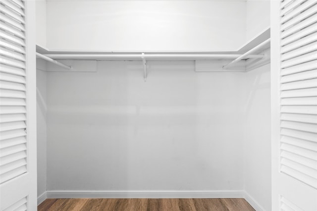 walk in closet featuring dark wood-type flooring