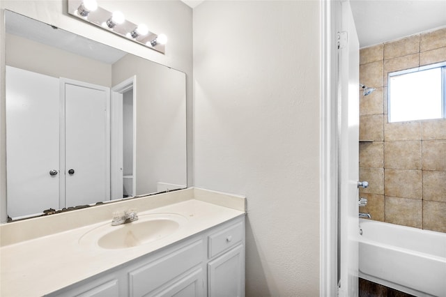 bathroom with vanity and tiled shower / bath combo