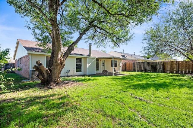 back of house with a lawn