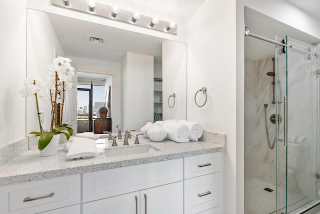 bathroom featuring vanity and walk in shower