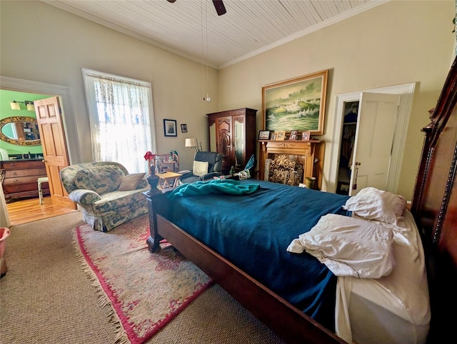 carpeted bedroom with ceiling fan and ornamental molding