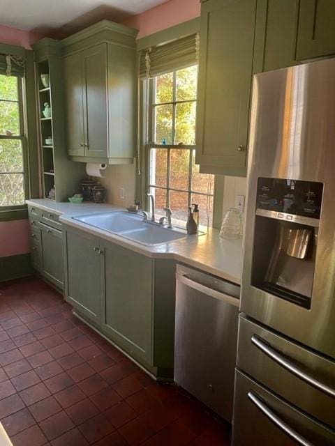 kitchen with sink, a healthy amount of sunlight, green cabinetry, and appliances with stainless steel finishes