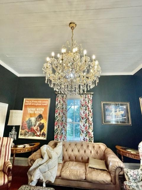 living room featuring an inviting chandelier and crown molding