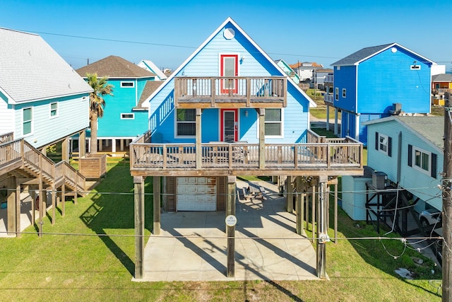 view of front of property featuring a balcony, a garage, and a front lawn