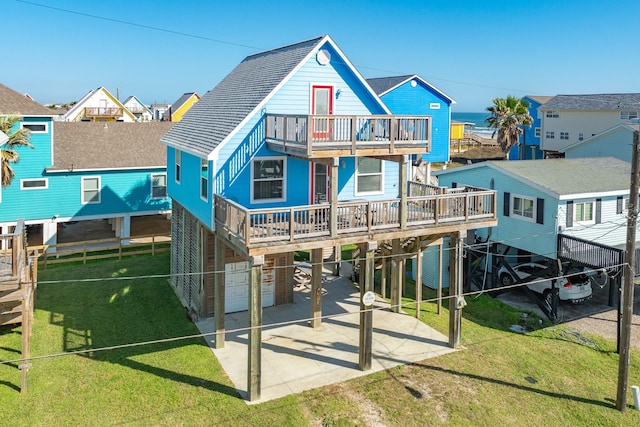 back of property featuring a lawn, a balcony, a patio, and a carport