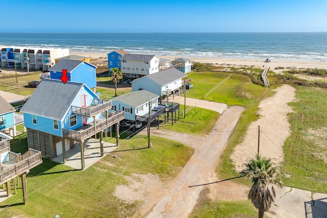 bird's eye view featuring a water view and a beach view