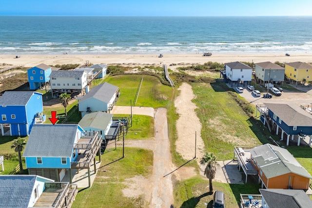 birds eye view of property with a water view and a view of the beach