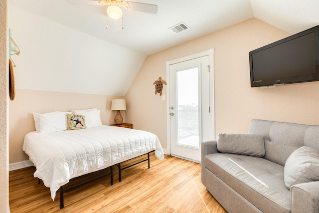 bedroom featuring access to outside, ceiling fan, light hardwood / wood-style floors, and vaulted ceiling