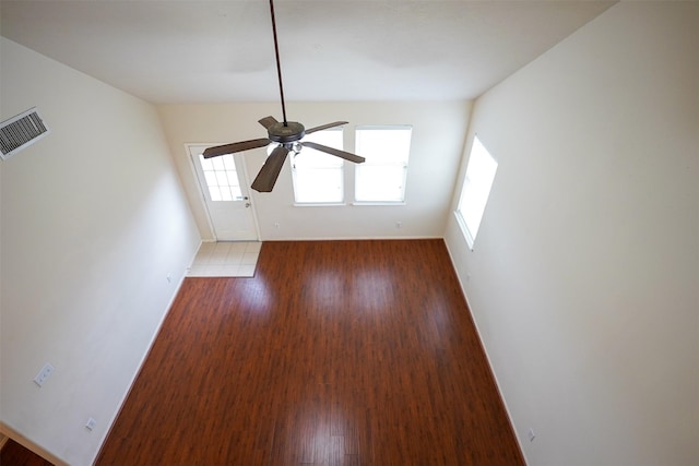 spare room with ceiling fan and dark hardwood / wood-style floors