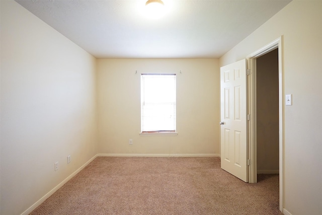 unfurnished room featuring light colored carpet