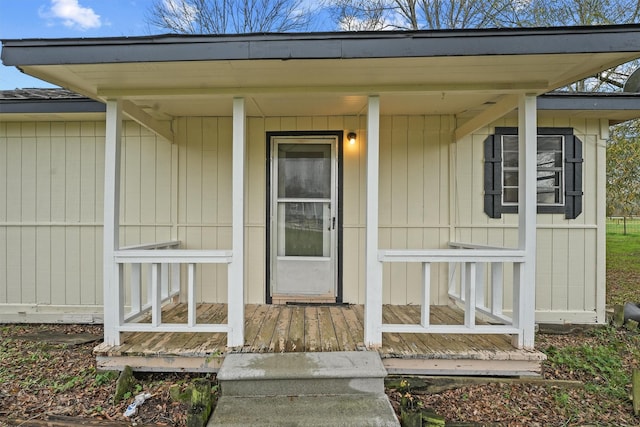 view of exterior entry featuring covered porch