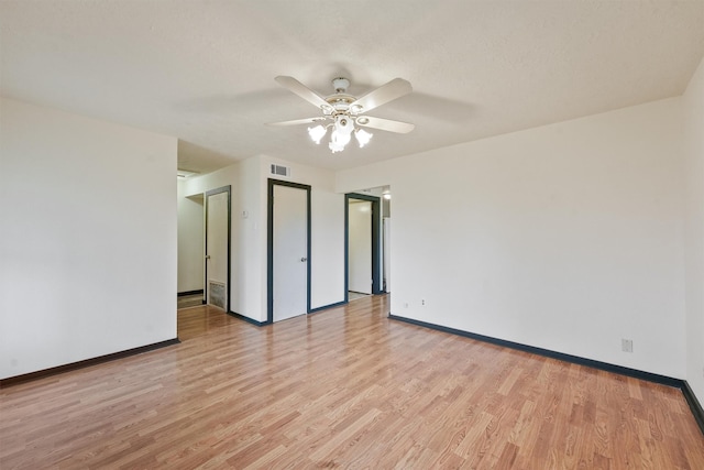 spare room with ceiling fan and light wood-type flooring